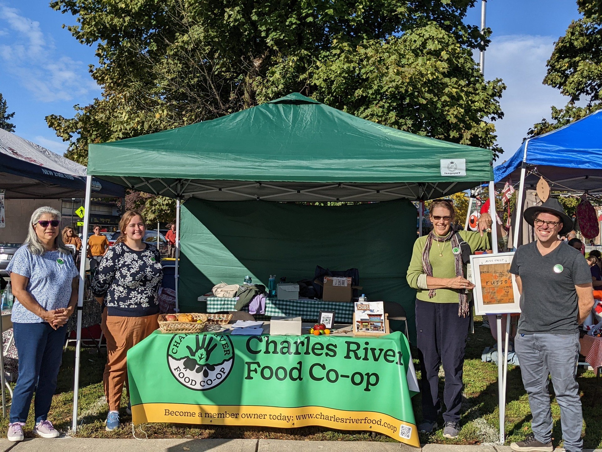 Our booth at the 2022 Newton Harvest Fair - we learned to hang the banner up with twine after this one!